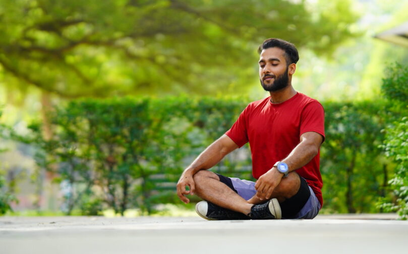 international yoga day image boy meditating in lotus position at park