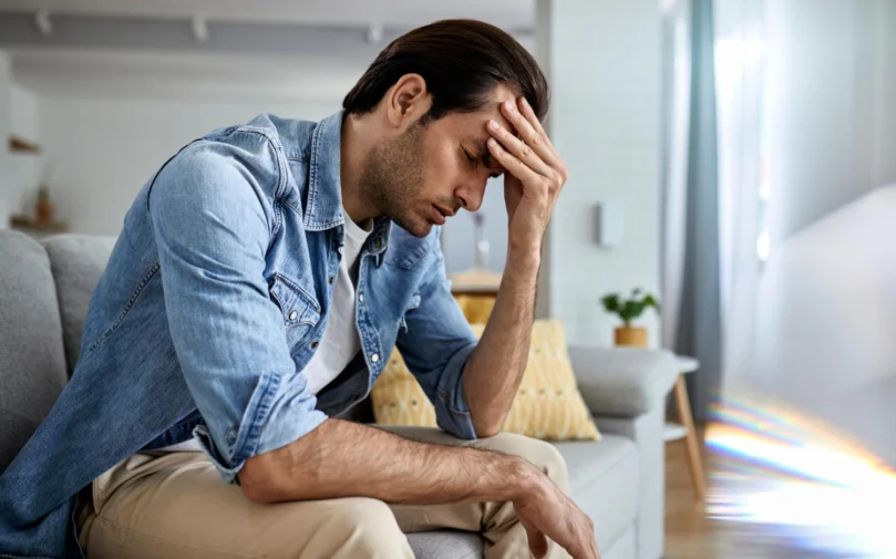 young-man-having-headache-holding-his-head-pain-home